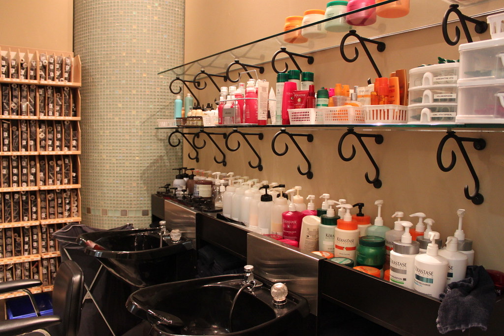 Inside a hair salon: wash basins and shelves of hair-care products