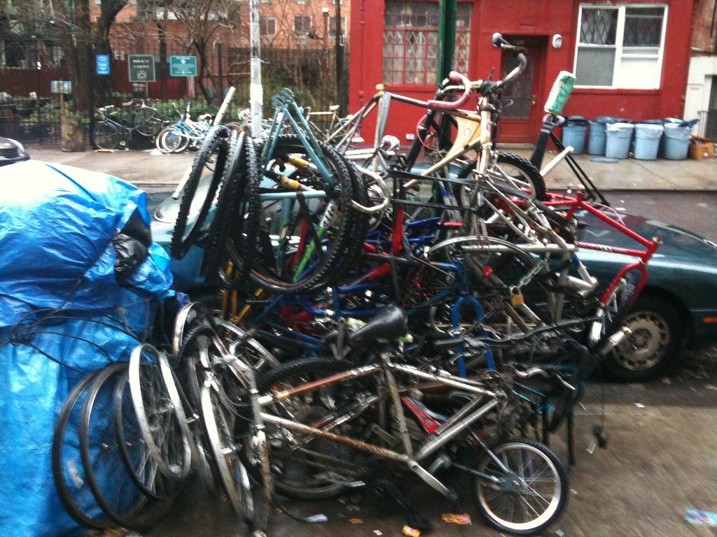 Bicycles stacked outside a small neighbourhood cycle shop
